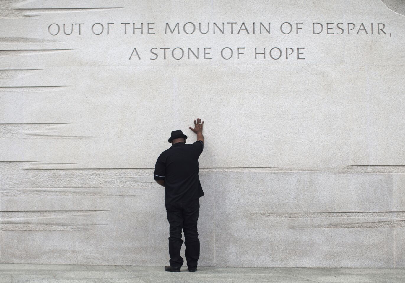 Rev. Bobby Turner of Columbus, Ohio, places his hand on the Martin Luther King Jr. Memorial in Washington. 2013 marked the 50th anniversary of King's March on Washington.