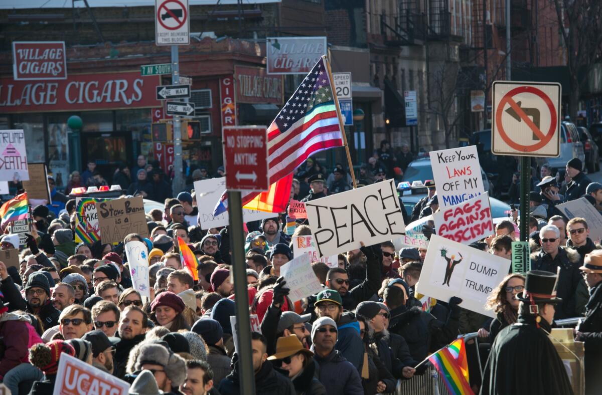 People rally in front of New York's Stonewall Inn on Saturday in solidarity with immigrants, asylum seekers, refugees, and the LGBT community.
