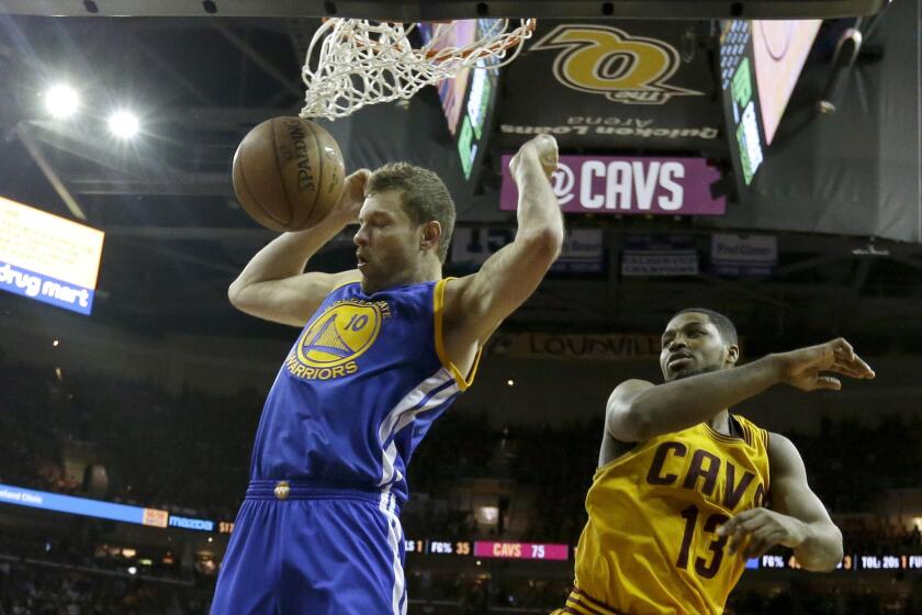 Golden State power forward David Lee dunks the ball in front of Cavaliers forward Tristan Thompson during the second half of Game 4 of the NBA Finals.