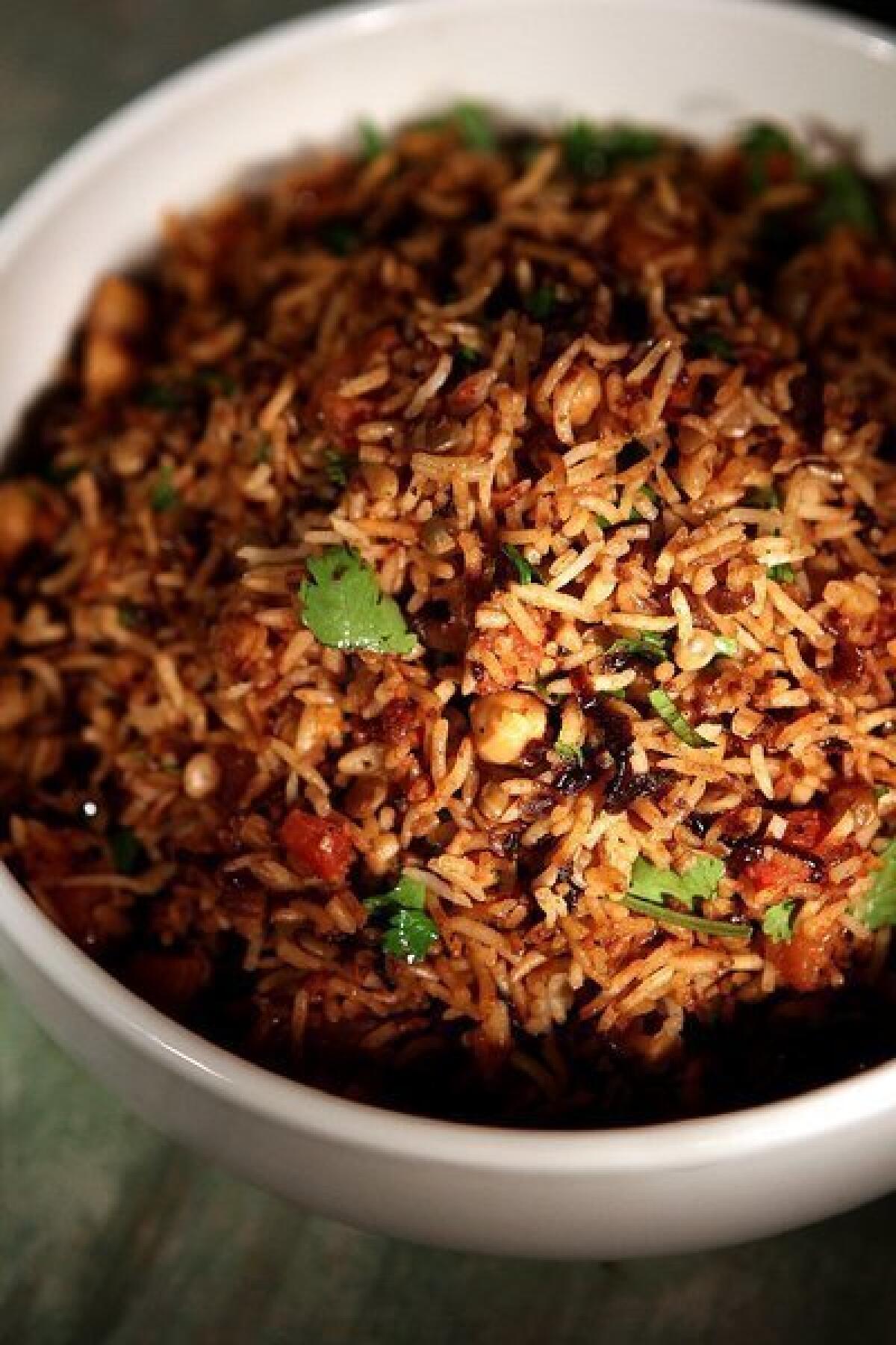 Rice pilaf with chickpeas, lentils and browned onions.