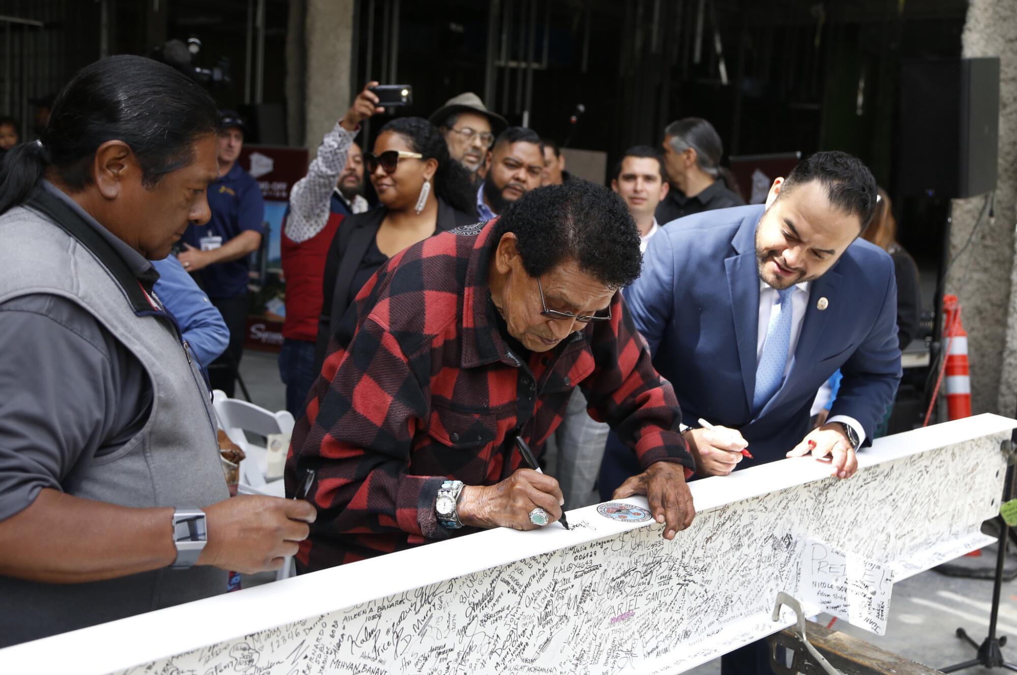 Former Sycuan Tribal Chairman Daniel Tucker, Tribal Elder George Prietto, and current Sycuan Tribal Chairman Cody Martinez sign the final steel beam of the tribe's first hotel in May 2018.