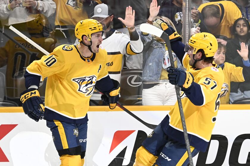 Nashville Predators center Colton Sissons (10) celebrates with defenseman Dante Fabbro (57) after Sissons scored against the St. Louis Blues during the second period of an NHL hockey game Saturday, April 1, 2023, in Nashville, Tenn. (AP Photo/Mark Zaleski)