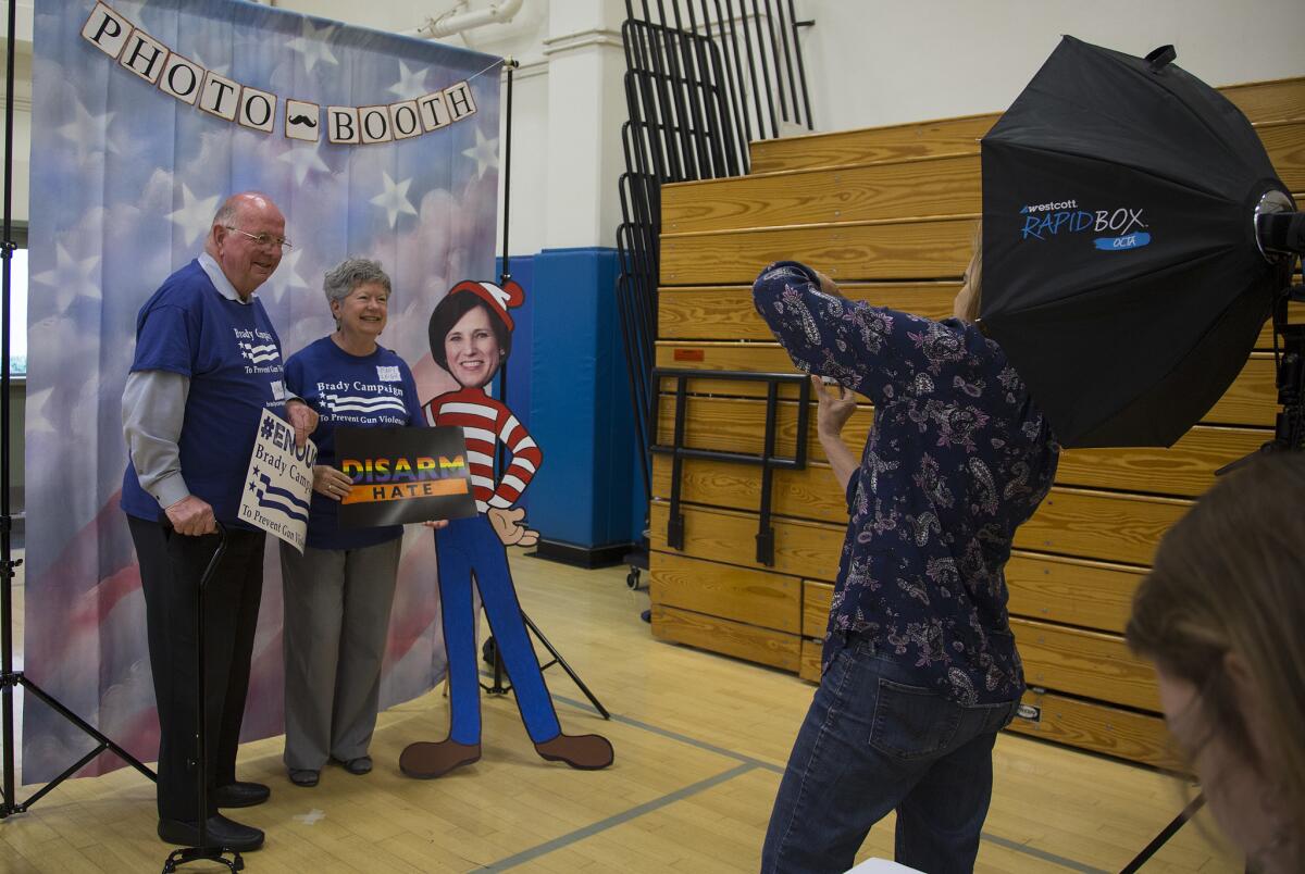 Charlie and Mary Leigh Blek of Trabuco Canyon get their photo taken with a cardboard cutout of Rep. Mimi Walters during a town hall meeting that Walters did not attend at Northwood High School on May 9 in Irvine.