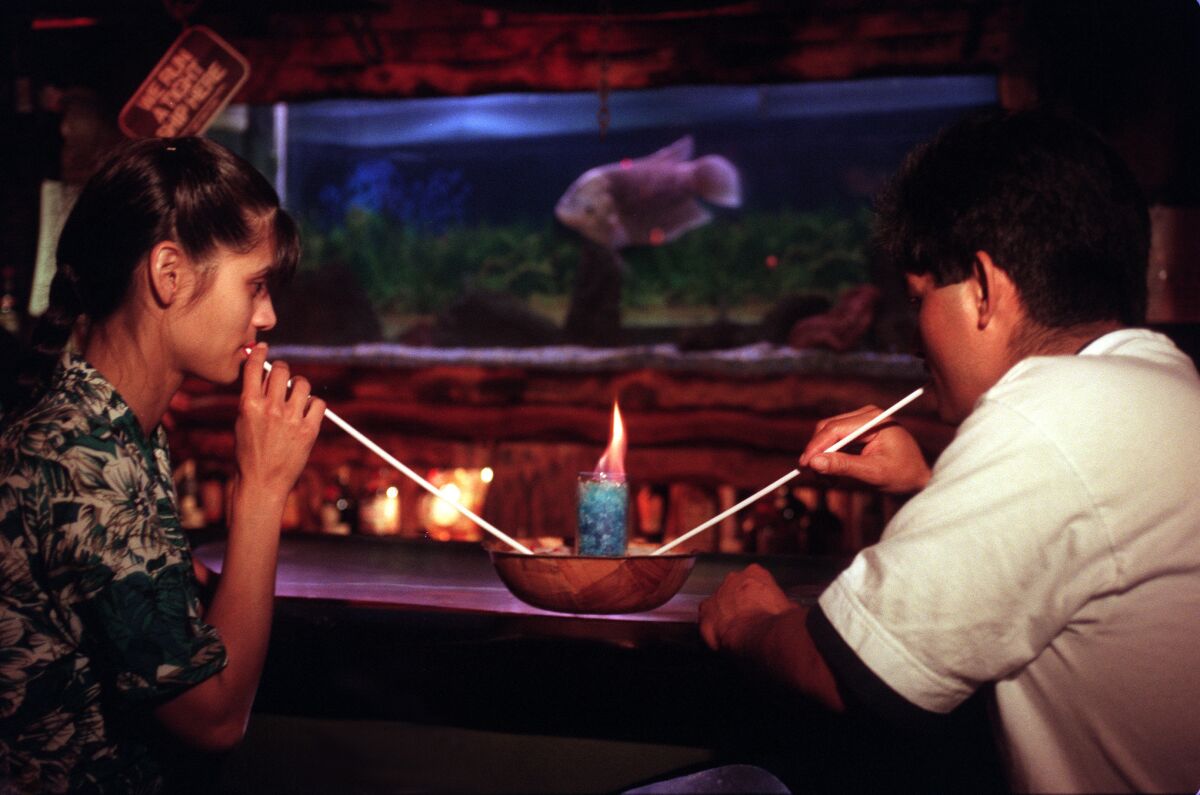 A young couple enjoy a flaming honey bowl  at the Bahooka Ribs & Grog restaurant in Rosemead.
