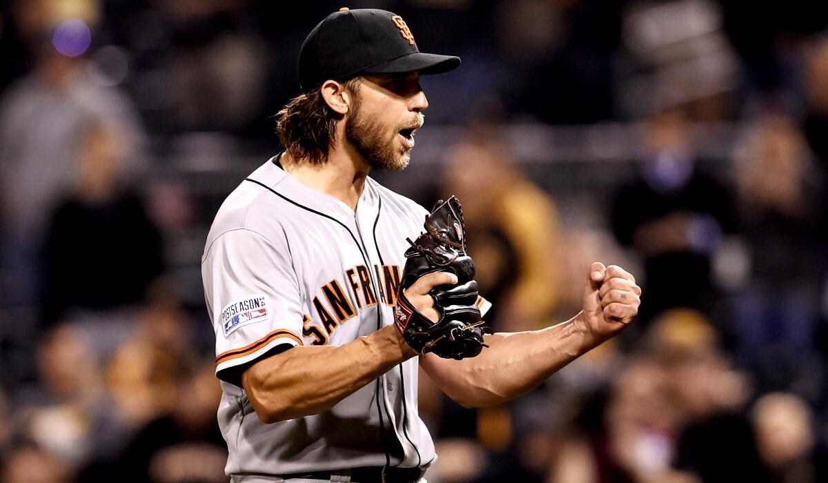 Giants starting pitcher Madison Bumgarner celebrates after recording the final out in his four-hit shutout of the Pirates on Wednesday night in Pittsburgh.