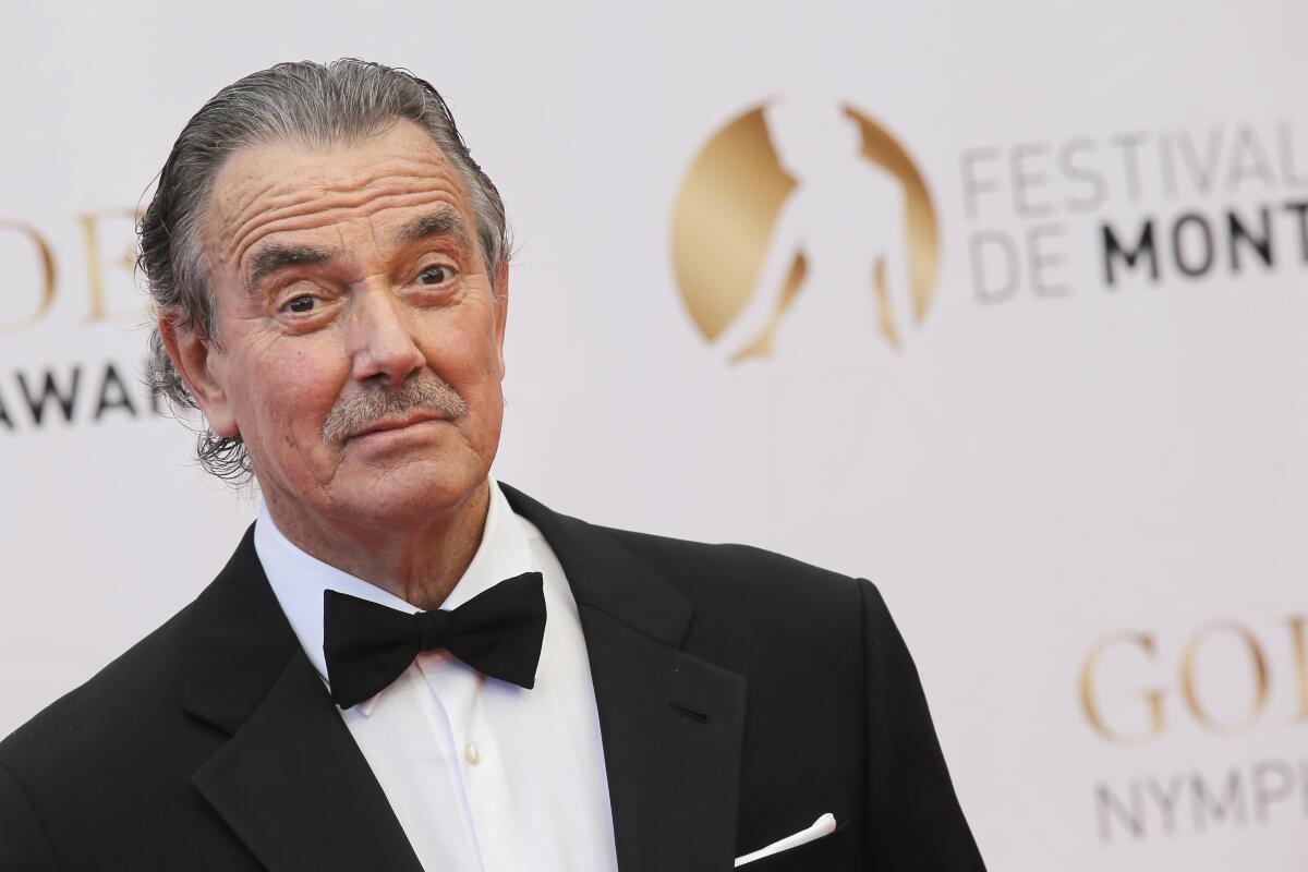 Eric Braeden wearing a tuxedo and standing in front of an awards backdrop