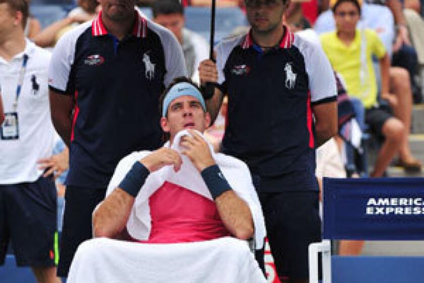 Juan Martin Del Potro sits on the sidelines as rain falls during his match against Guillermo Garcia-Lopez on Wednesday.