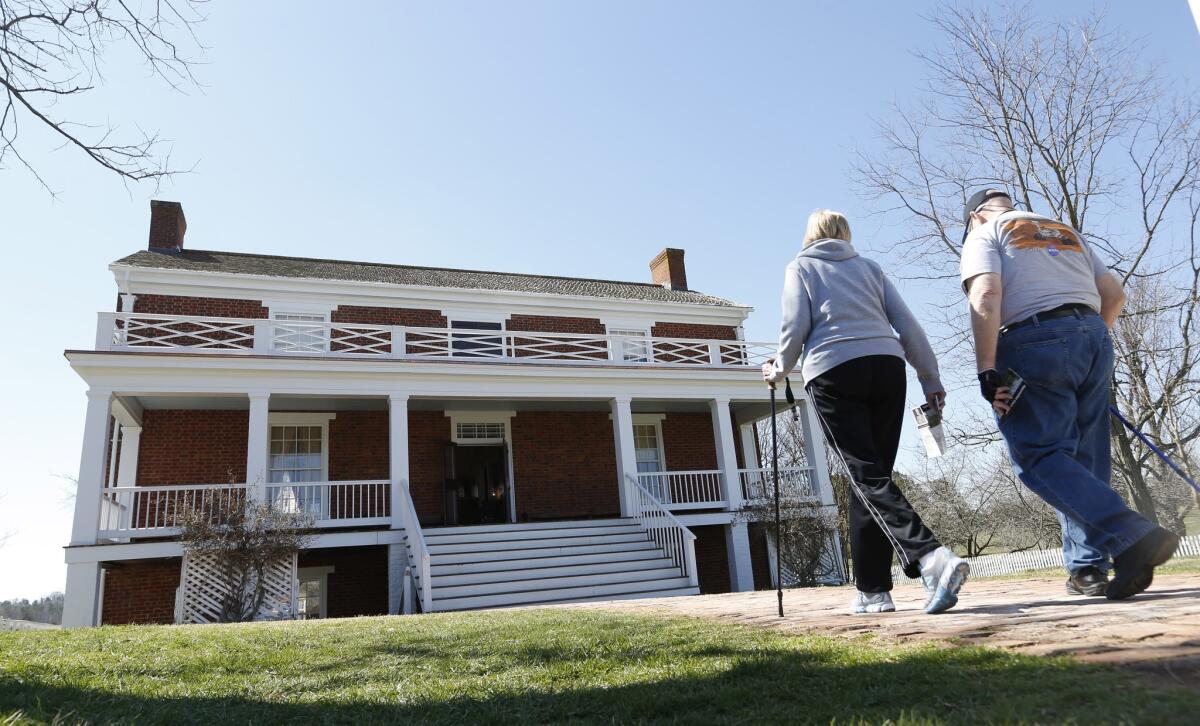 Visitors walk to the McLean house at the Appomattox Court House National Historical Park on April 1. On April 9, 1865, Confederate Gen. Robert E. Lee surrendered to Union Gen. Ulysses S. Grant in the front parlor of the home of Wilmer McLean.