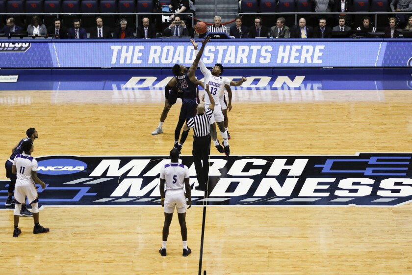 FILE - In this March 19, 2019, file photo, Fairleigh Dickinson's Kaleb Bishop (12) and Prairie View A&M's Iwin Ellis (13) leap for the opening tip-off in the first half of a First Four game of the NCAA college basketball tournament in Dayton, Ohio. NCAA President Mark Emmert told the organization's more than 1,200 member schools Friday, June 18, 2021, that he will seek temporary rules as early as July to ensure all athletes can be compensated for their celebrity with a host of state laws looming and congressional efforts seemingly stalled. (AP Photo/John Minchillo, File)