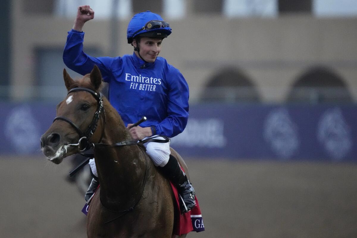 William Buick celebrates atop Modern Games after winning the Breeders' Cup Juvenile Turf race at Del Mar.