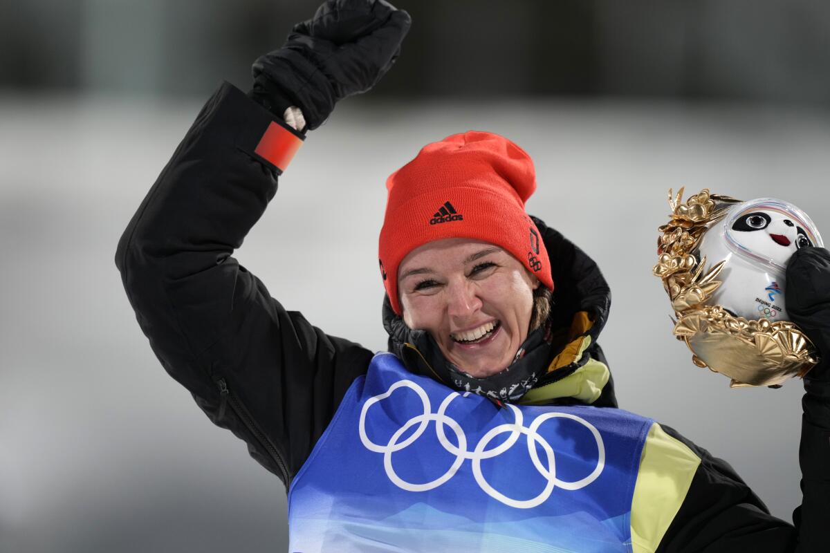 Denise Herrmann of Germany stands on the podium after winning gold in the women's 15-kilometer individual race.