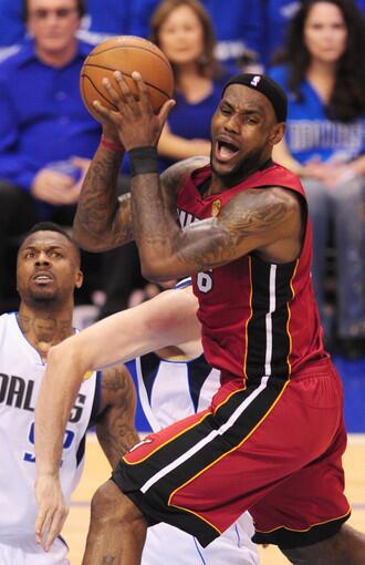 LeBron James (R) of the Miami Heat is defended Dirk Nowitzki (obscured) and DeShawn Stevenson (L) of the Dallas Mavericks during Game 4 of the NBA Finals at the American Airlines Center in Dallas.