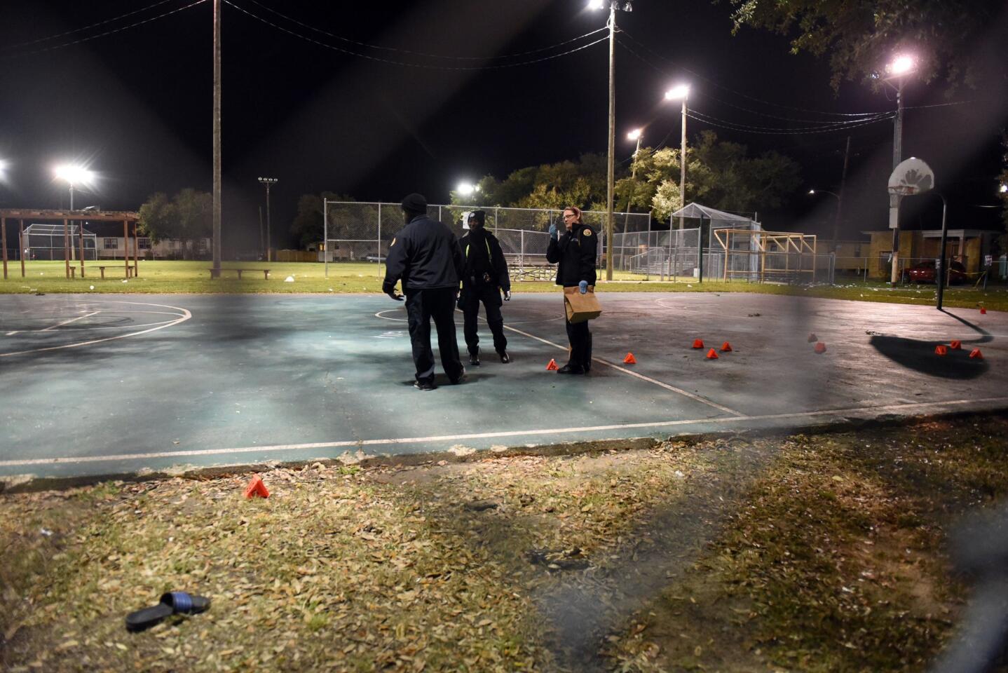 Police gather evidence after a shooting at a playground on November 22, 2015 in New Orleans, Louisiana.