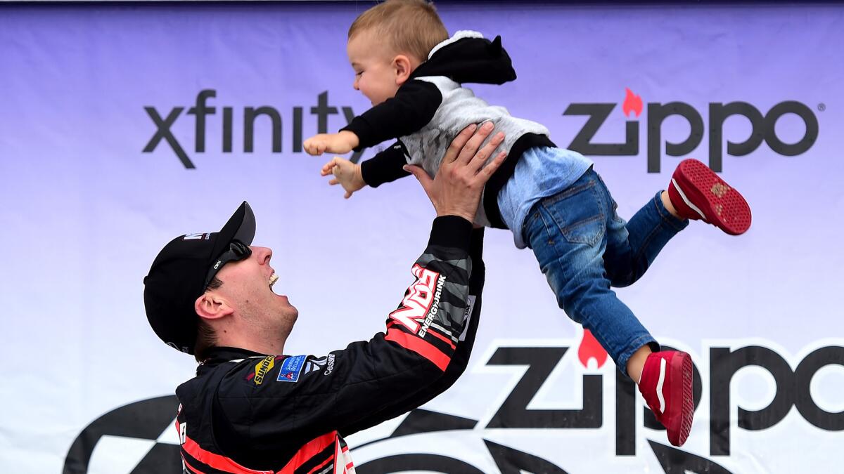 NASCAR driver Kyle Busch celebrates along Victory Lane with son Brexton after winning the Xfinity Series Zippo 200 at Watkins Glen International on Saturday.
