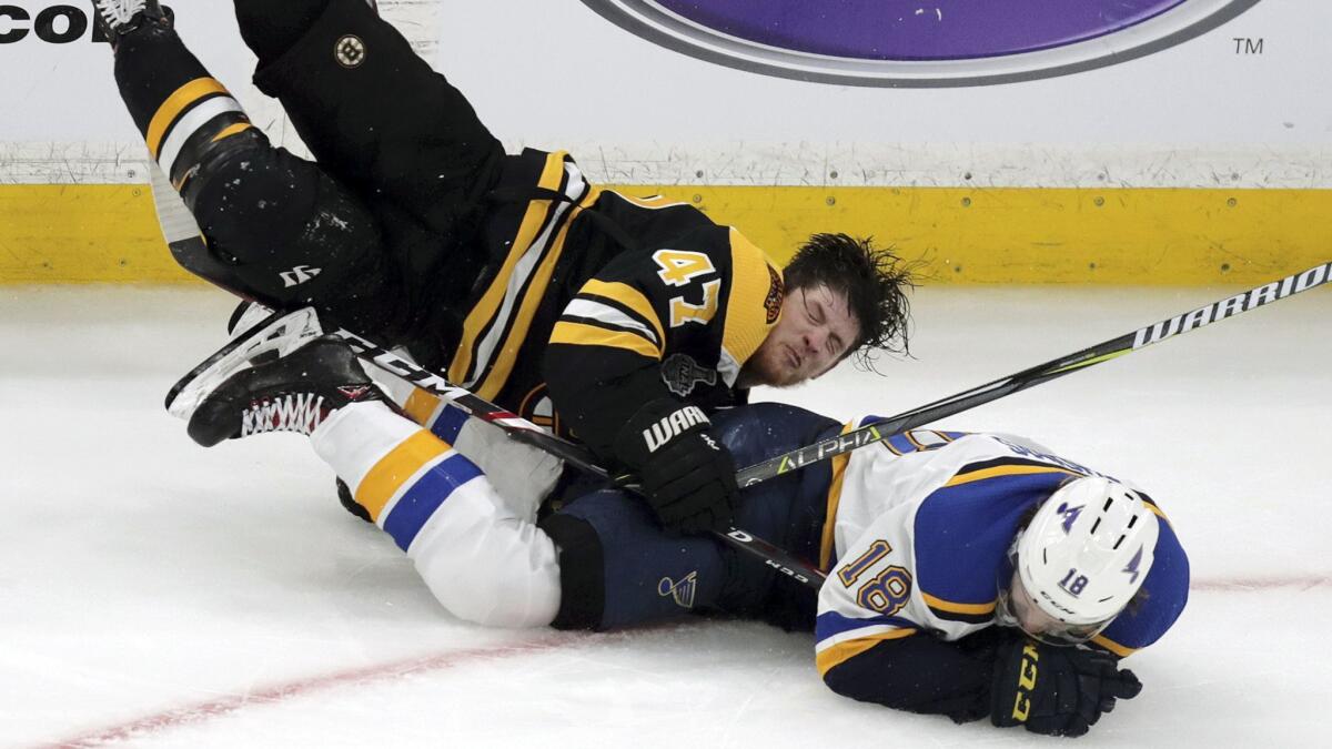 Boston's Torey Krug, left, and St. Louis' Robert Thomas crash to the ice during Game 1 of the Stanley Cup Final on May 27 at TD Garden.