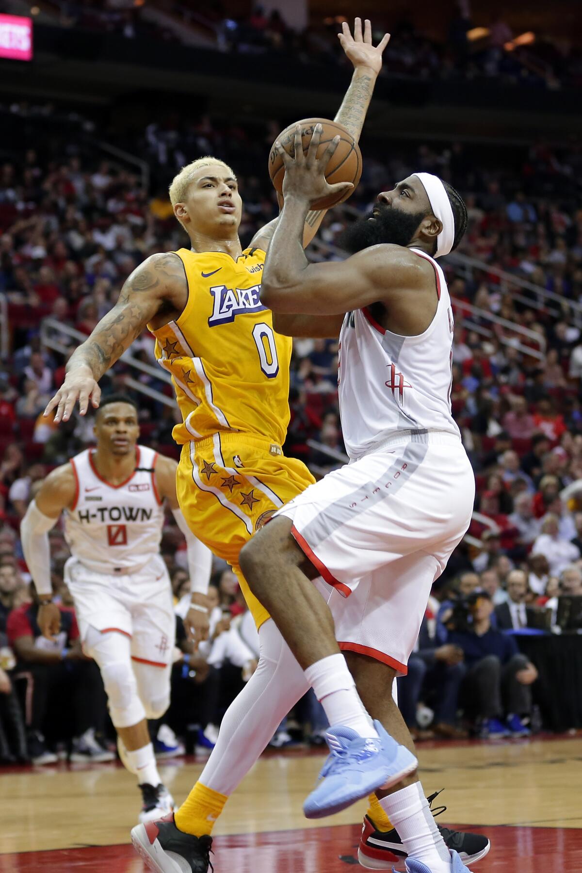 Kyle Kuzma pressures James Harden into a shot during the second half of Saturday's game.