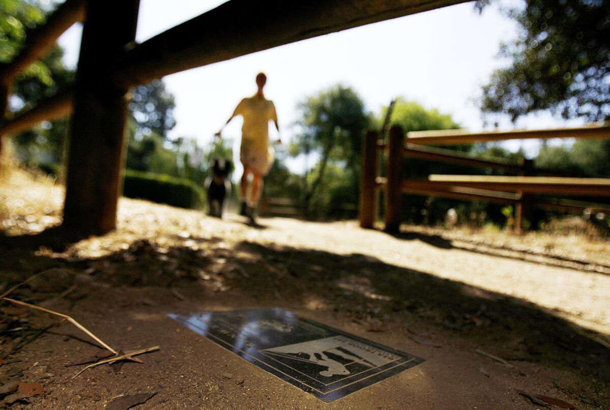 A Boy Scout Eagle Scout marker at a trailhead of the Flint Canyon Trail at Commonwealth Avenue and Berkshire Avenue in La Cañada Flintridge on Tuesday, June 18, 2013. The markers note the completion of a trail related project that a Boy Scout did to become an Eagle Scout and the city's Parks and Recreation Commission has recommended to leave them in place. Trail advocates want to see them removed, but Scout leaders want them to remain.