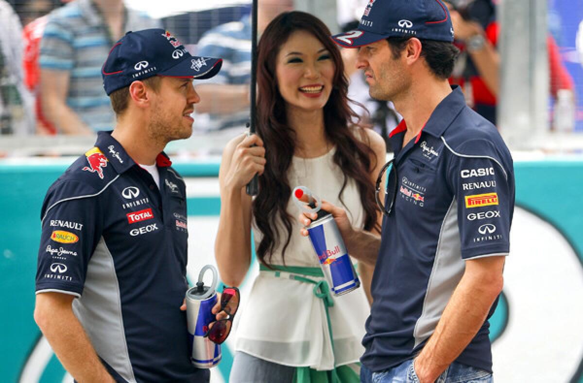 Formula One drivers Sebastian Vettel, left, and Mark Webber during the introductions before the start of the Malaysia Grand Prix last month.