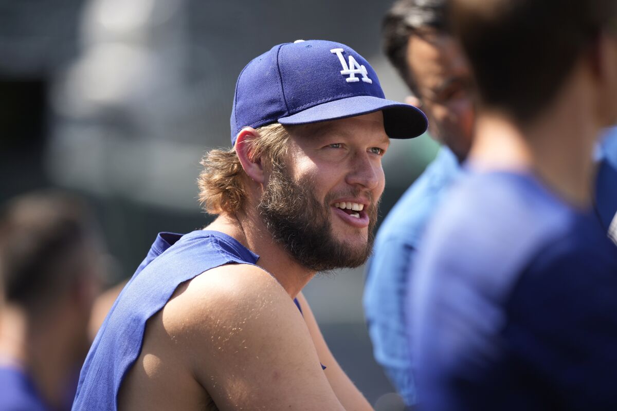 Dodgers pitcher Clayton Kershaw talks to reporters during batting practice on July 17 in Denver.