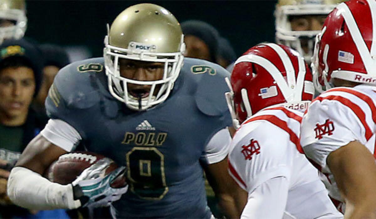 Long Beach Poly's John "Juju" Smith gets a first down against Mater Dei back in November.