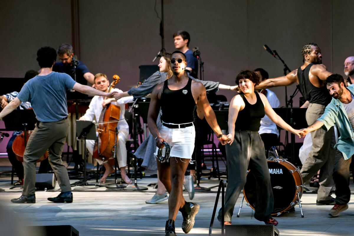 Performers hold hands onstage for the AMOC finale at the Ojai Music Festival.
