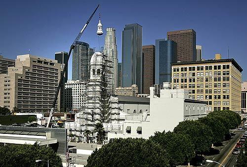 To Los Angeles preservationists, it was the icing on the cake--or at least the long-awaited, decorative top layer. A crane positioned the 3,500-pound cupola over the former St. Vibiana Cathedral on Wednesday, capping an 11-year campaign to save the historic downtown landmark. After the sanctuary was heavily damaged by the 1994 earthquake, the Catholic Archdiocese of Los Angeles had targeted the 131-year-old church for demolition. but conservationists sued. At the ceremony Wednesday, developer Tom Gilmore said, "No chunks fell off. If anything, I was expecting lightning bolts to strike."