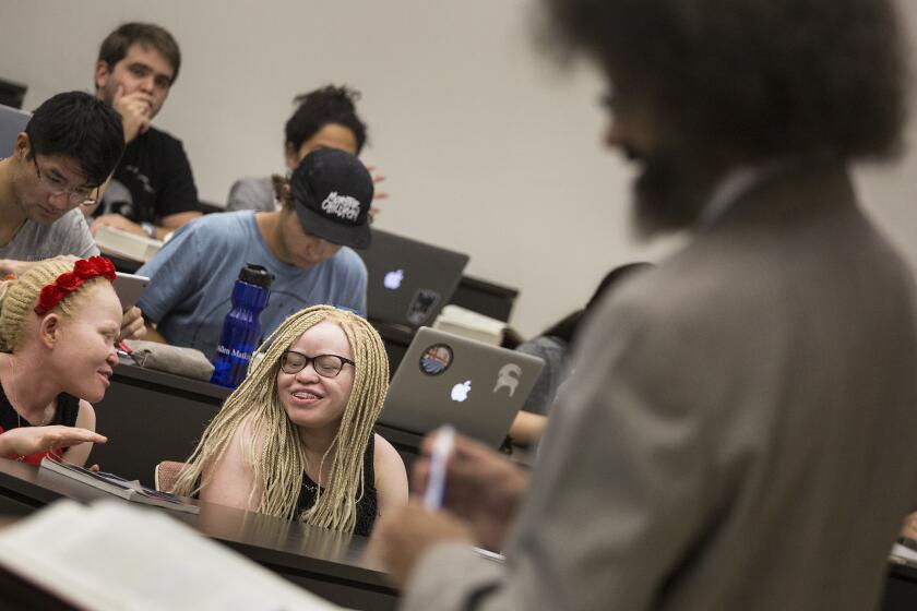 Tindi, left, and Bibiana Mashamba, albino sisters from Tanzania, sit in on professor Jody Armour's USC tort law class on Aug. 24. They just received asylum in the U.S.