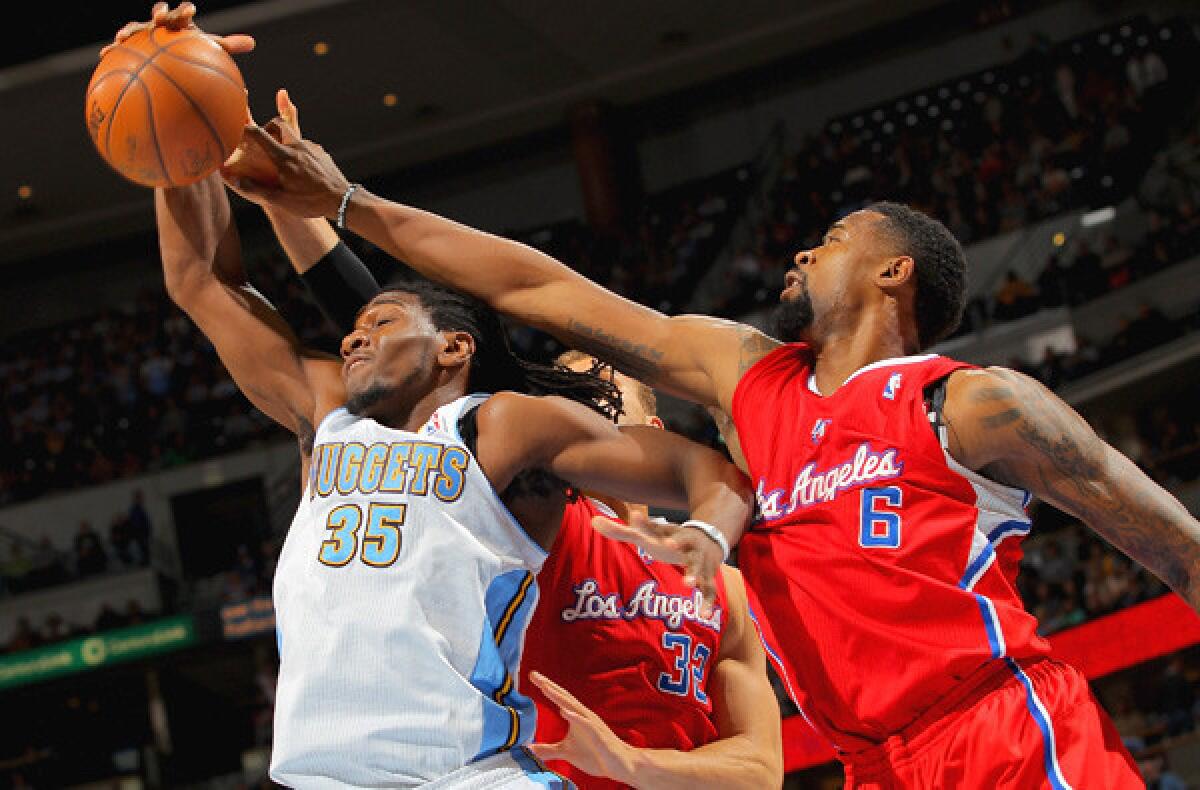 Clippers big men DeAndre Jordan (6) and Blake Griffin (32) battle Nuggets power forward Kenneth Faried (35) for a rebound in a game last season.