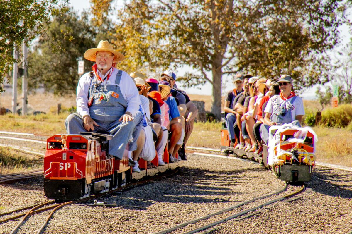 Model engineers pilot passengers on parallel tracks during a 2018 Scarecrow Festival in Fairview Park in Costa Mesa.