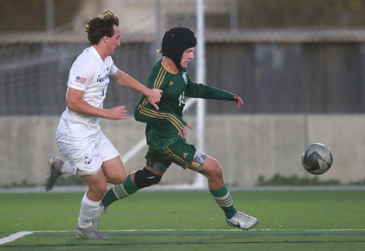 Edison's Nathan Jackson (16) runs down the sideline as he chases a long pass against Newport Harbor on Monday.