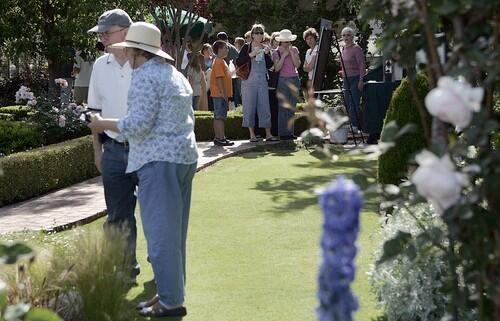 Tour goers browse through the Ferees' 3/4 acre garden during a garden tour honoring Mary Lou Heard, in Huntington Beach.