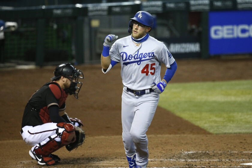 The Dodgers' Matt Beaty celebrates a fourth-inning home run as Diamondbacks catcher Carson Kelly looks on.