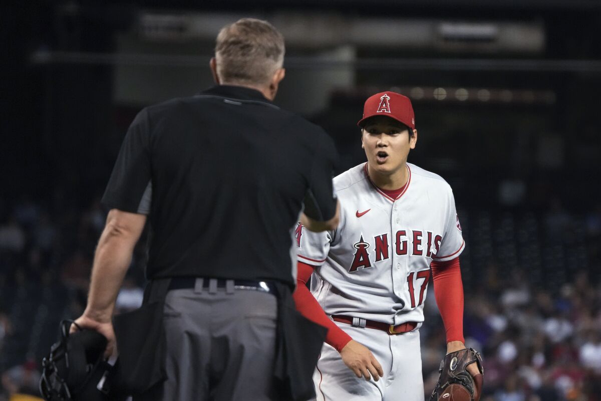 Angels pitcher Shohei Ohtani talks to umpire Greg Gibson after being called for his second balk during the fifth inning.