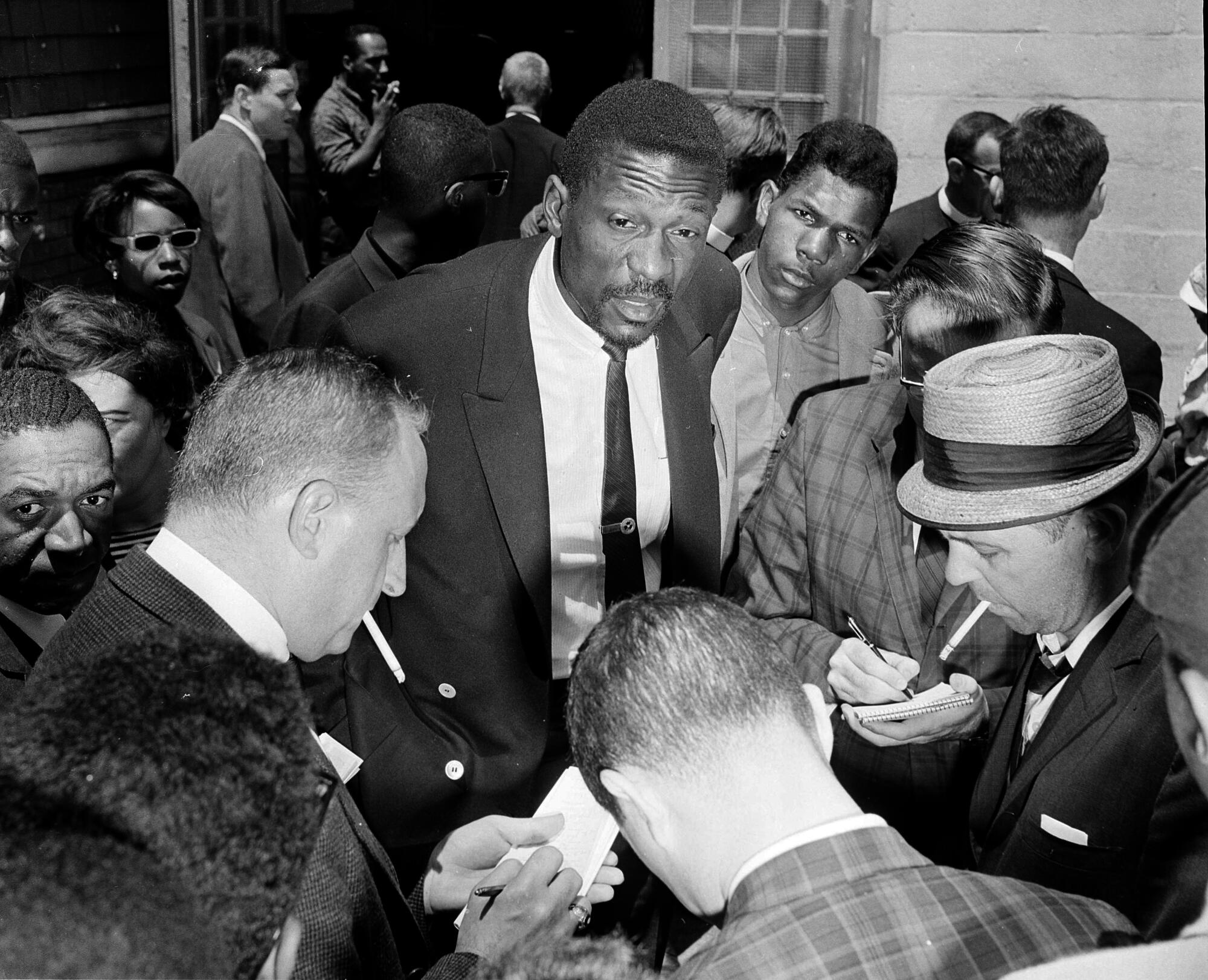 Celtics star Bill Russell talks with reporters about the boycott of Boston public schools by African Americans.