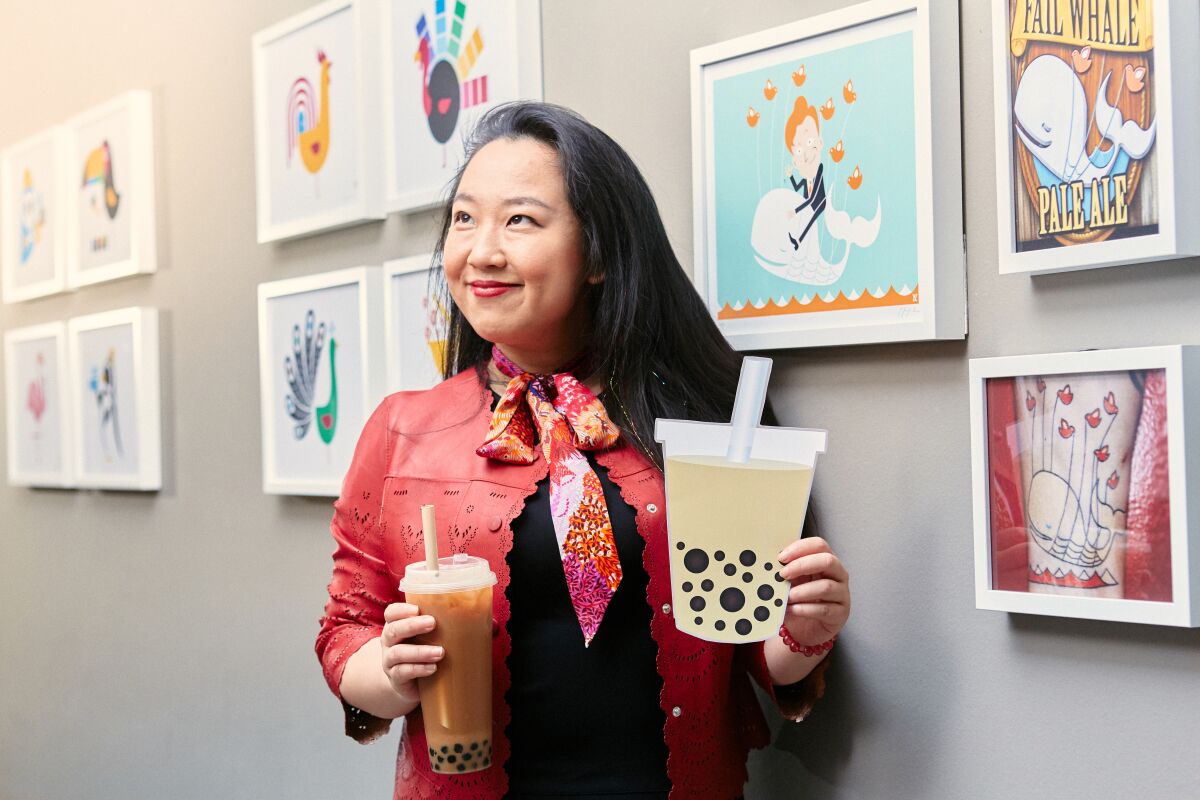 San Francisco, CA - February 12, 2020: Yiying Lu designer of the boba emoji infront of an exhibiition of her art.