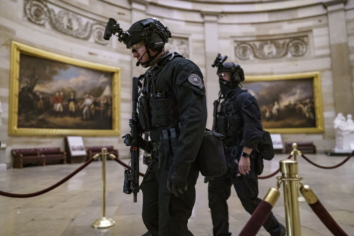 FILE - Members of the U.S. Secret Service Counter Assault Team walk through the Rotunda