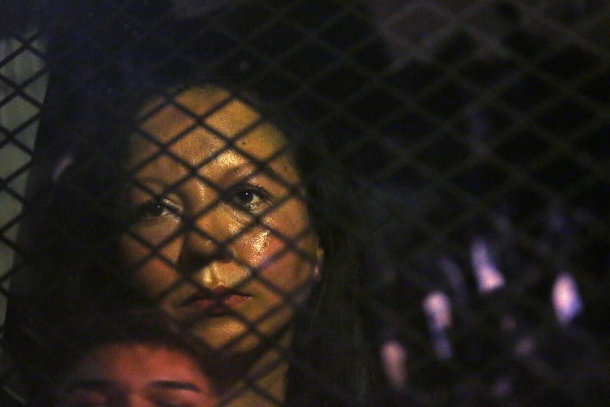 Guadalupe Garcia de Rayos is locked in a van that is stopped in the street by protesters outside an Immigration and Customs Enforcement facility Feb. 8 in Phoenix.