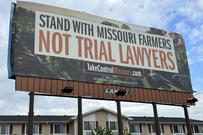 A billboard supporting legislation that would provide legal protection to manufacturers of pesticides such as Bayer's popular weedkiller Roundup, is shown in Jefferson City, Mo., on May 13, 2024. (AP Photo/David A. Lieb)