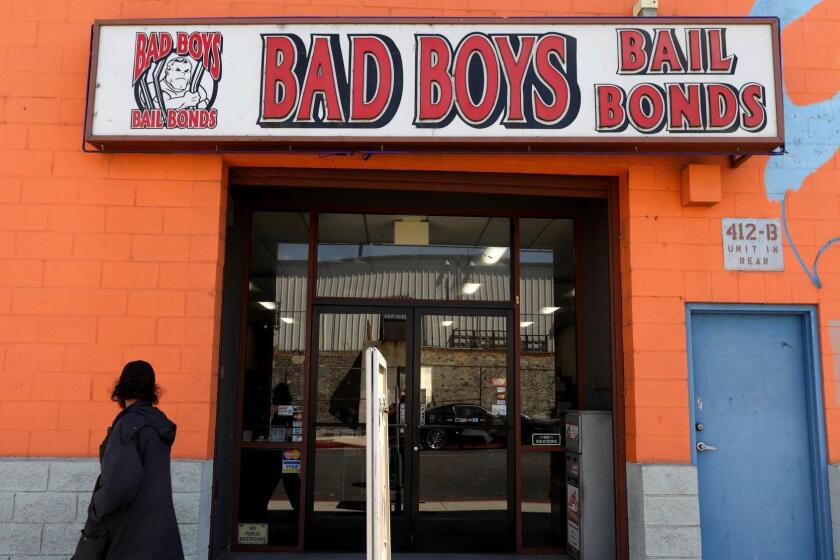 A person walks past Bad Boys Bail Bonds in Los Angeles.