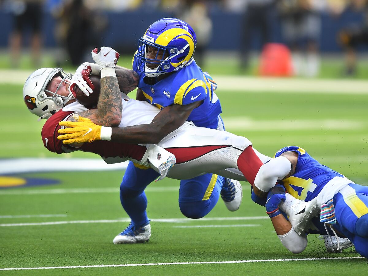  Cardinals tight end Maxx Williams is tackled by the Rams' Ernest Jones, left, and Taylor Rapp. 