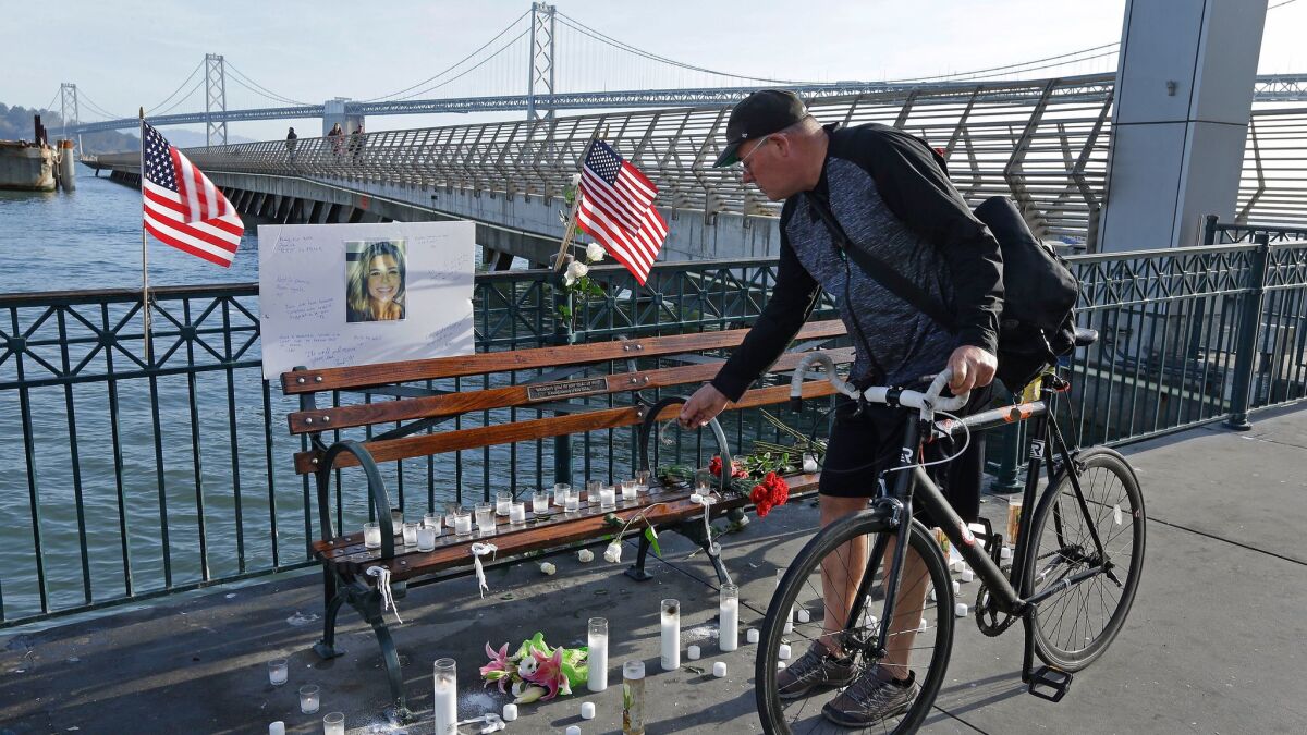 A cyclist visits a memorial site for Kathryn Steinle at Pier 14 in San Francisco on Dec. 1.