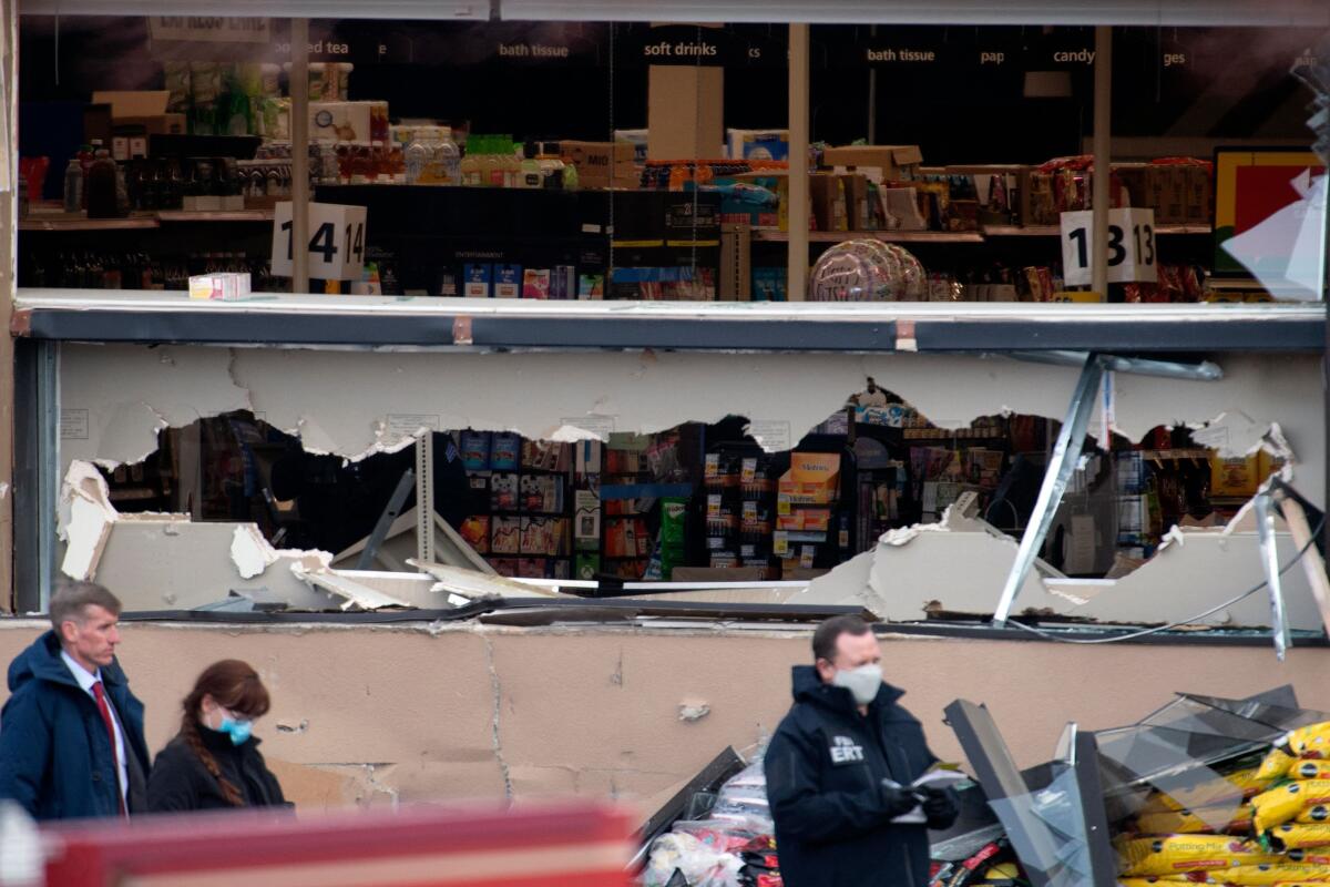 Shattered windows and the damaged facade of the King Soopers grocery store in Boulder, Colo.