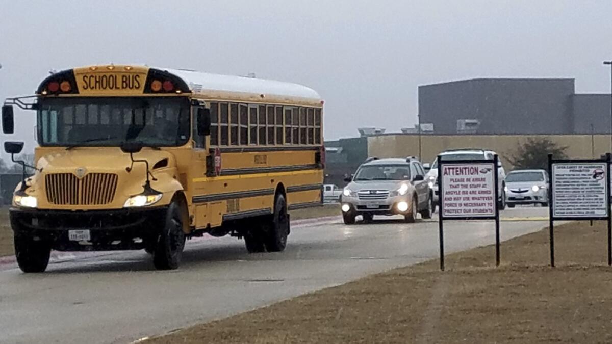 Signs alert those approaching Argyle High School that staff are armed.
