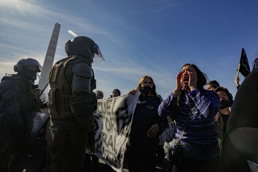 People protest the contamination produced by the Ventanas Smelter, of the state-owned company Codelco, on the first day of its closure, at the site of the smelter in Quintero Bay in Puchuncavi, Chile, Wednesday, May 31, 2023. Chilean President Gabriel Boric announced in June 2022 the gradual closure of the world's leading copper producer in order to reduce the constant episodes of environmental pollution that affect the coastal communes near the furnace. (AP Photo/Esteban Felix)