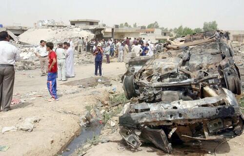 Residents of Tall Afar, Iraq, inspect the wreckage of a house where a double suicide bombing killed 34 people.