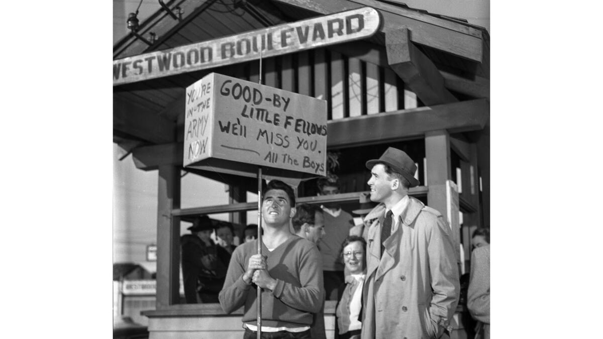 Mar. 22, 1941: Actor Jimmy Stewart standing at Westwood train depot at 7:15 a.m. with fans saying good-by.