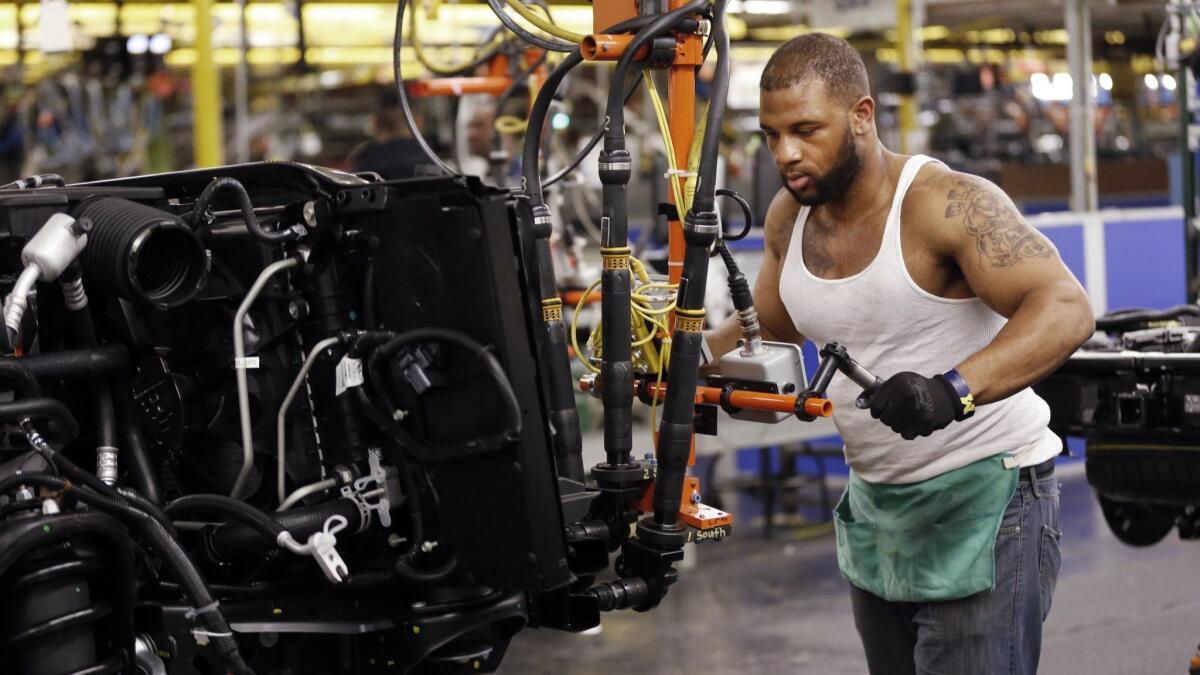 Stephen Carpenter works on an SUV at the General Motors plant in Arlington, Texas.