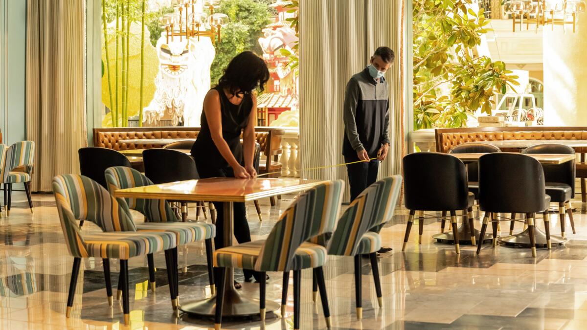 Employees at Sadelle's restaurant at Bellagio measure where to place tables to maintain social distancing. The resort is accepting reservations beginning June 1.