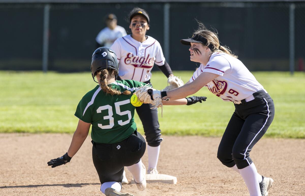 Estancia's Grace Young tags out Costa Mesa's Sydnie Pulido on Wednesday.
