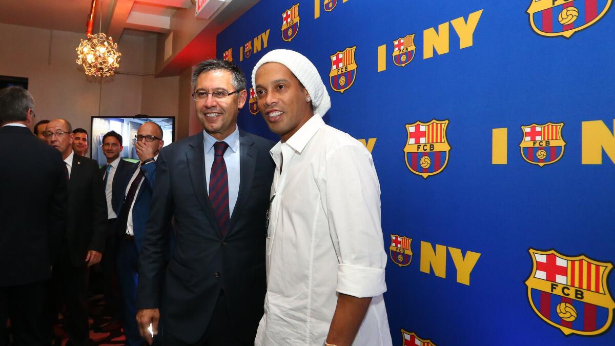 FC Barcelona President Josep Maria Bartomeu, left, and Ronaldinho pose at a party in New York City on Sept. 6.